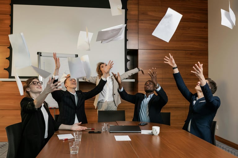 Diverse team celebrating FICA tax savings and employee benefits in a modern office environment